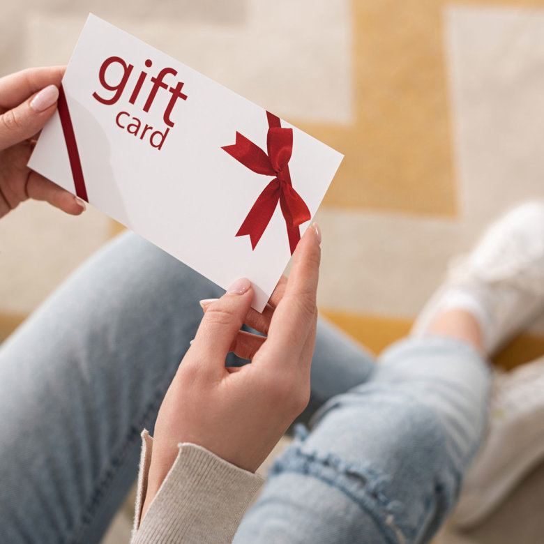 girl-holding-gift-card-with-red-bo-opti